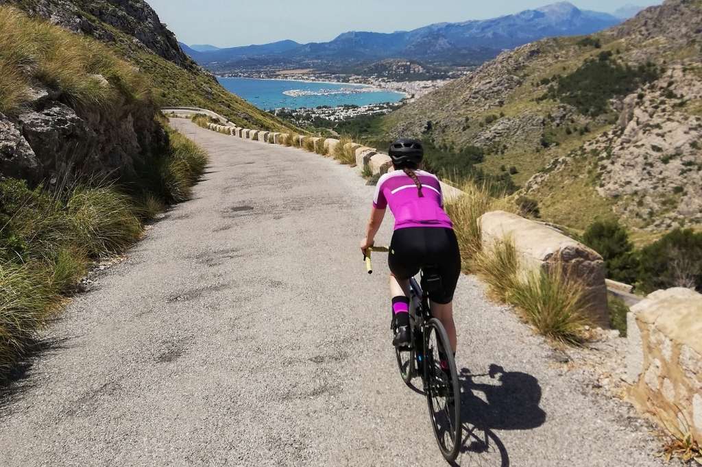 Young woman cycling on the roads of Mallorca