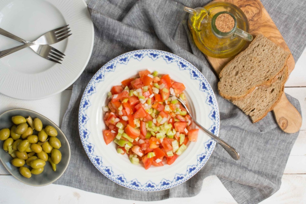 A Trampó salad is a traditional dish made with a base of bread, tomatoes, peppers, and onions